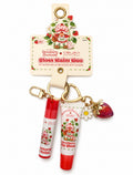 Strawberry Shortcake x Célavi limited edition Gloss Balm Duo keychain with strawberry lip gloss, lip balm, daisy and strawberry charms